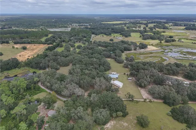 a backyard of a house with plants and wooden fence