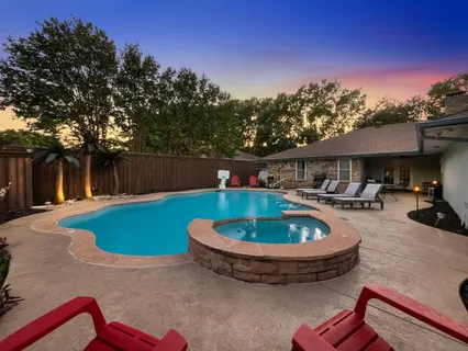 a swimming pool with outdoor seating and yard