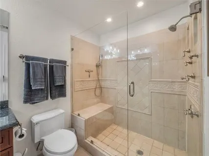a bathroom with a toilet a sink and shower