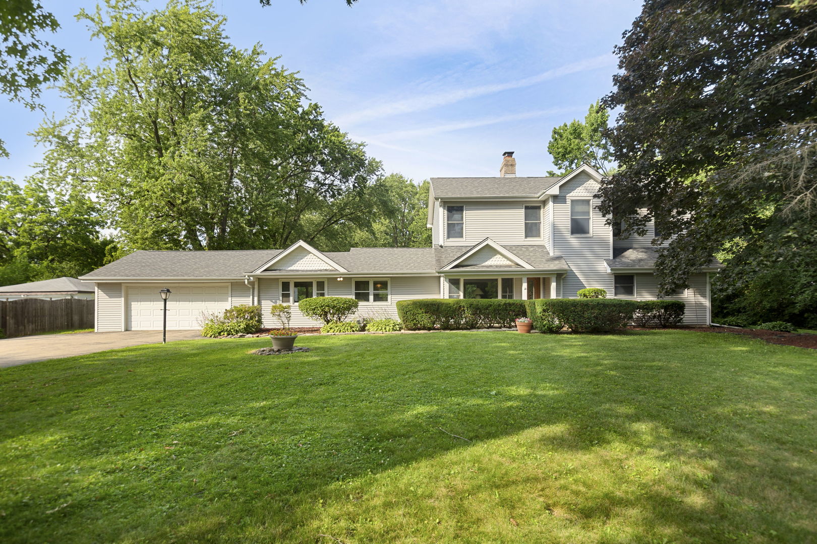 7062 Osage Road Long Grove, IL 60060 - Photo 1 of 25 a front view of a house with a garden