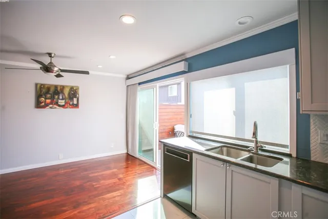 a kitchen with stainless steel appliances granite countertop a sink and a refrigerator