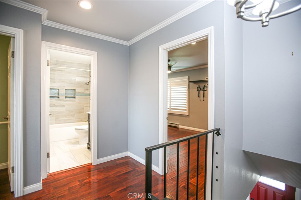 11058 Grant Way Stanton, CA 90680 - Photo 17 of 40 a view of a hallway with wooden floor and staircase