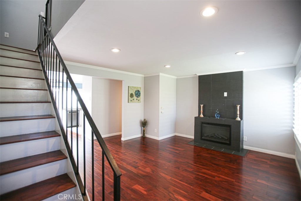 11058 Grant Way Stanton, CA 90680 - Photo 3 of 40 a view of a livingroom with wooden floor and stairs