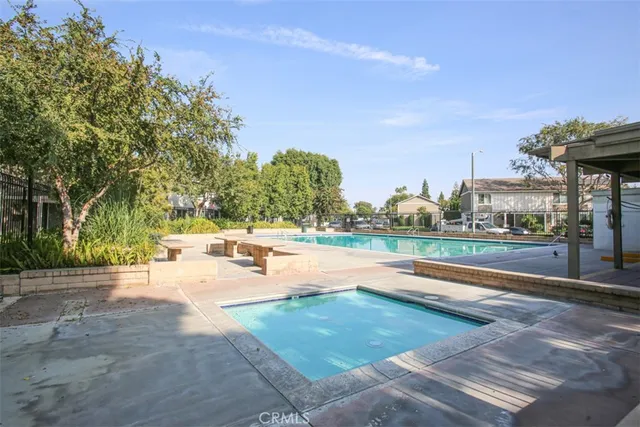 a view of a swimming pool with a patio and a yard