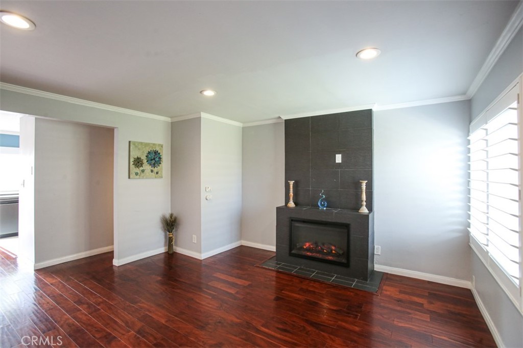 11058 Grant Way Stanton, CA 90680 - Photo 5 of 40 an empty room with wooden floor and windows