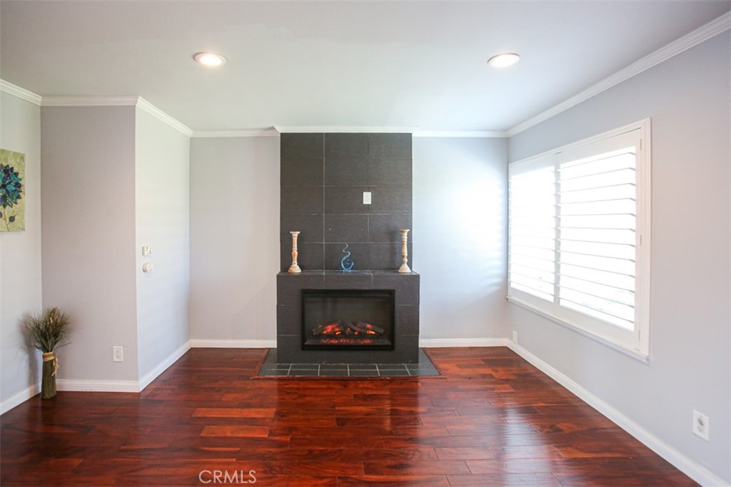 11058 Grant Way Stanton, CA 90680 - Photo 6 of 40 a room with fireplace and wooden floor