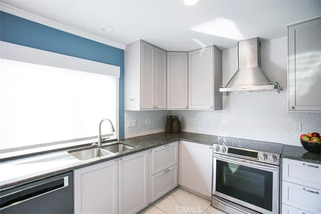 a kitchen with granite countertop a sink stainless steel appliances and cabinets