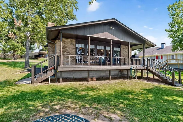 an outdoor view of house with swimming pool and sitting area