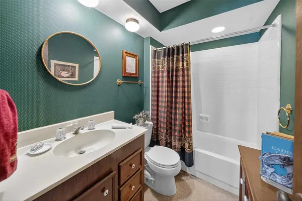 a bathroom with a sink a toilet and a mirror