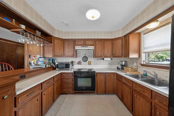 a kitchen with a sink stove and cabinets