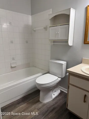 a bathroom with a toilet a sink and bathtub