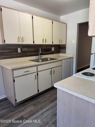 a kitchen with a sink and cabinets