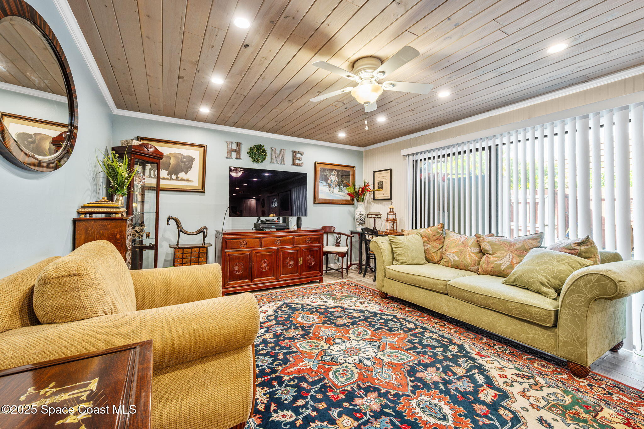 1511 Joshua Drive Northeast Palm Bay, FL 32905 - Photo 11 of 27 a living room with furniture ceiling fan and a rug