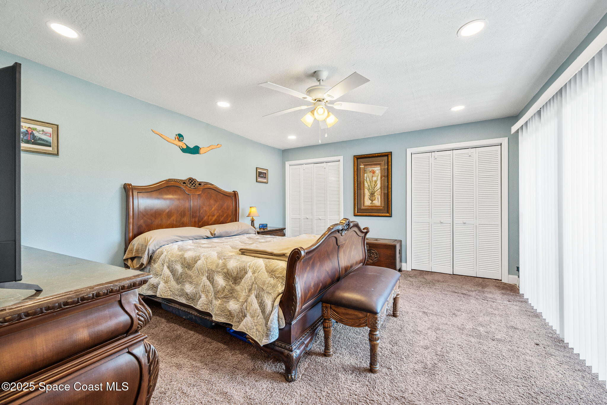 1511 Joshua Drive Northeast Palm Bay, FL 32905 - Photo 14 of 27 a bedroom with a bed and a chandelier