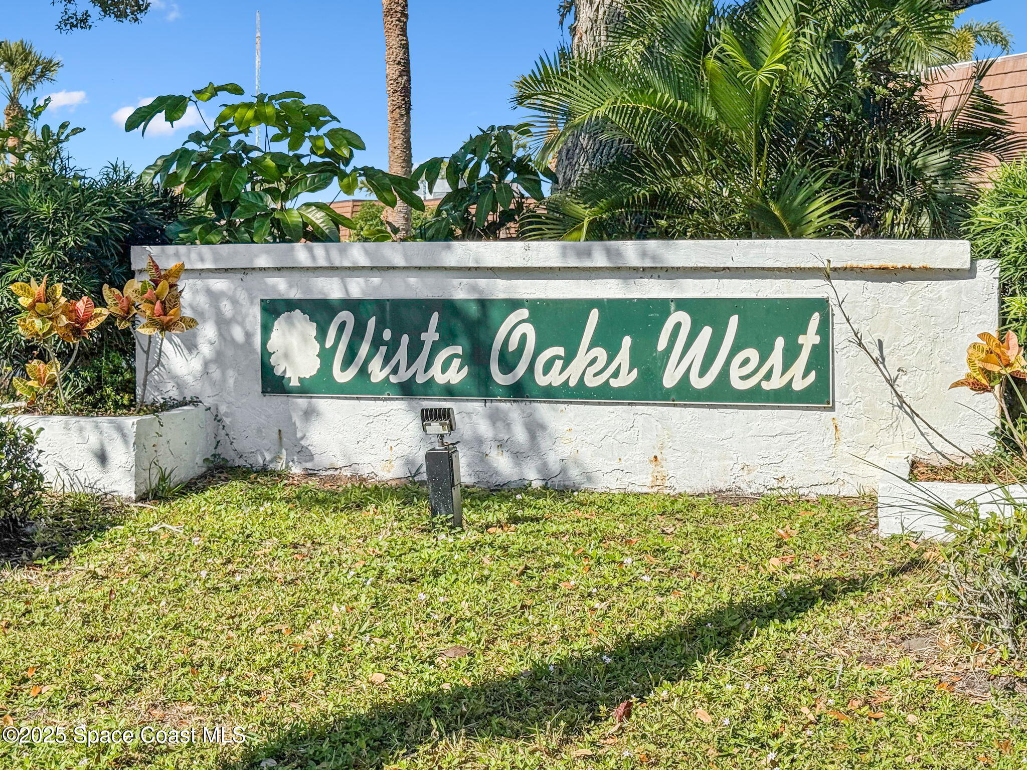 1511 Joshua Drive Northeast Palm Bay, FL 32905 - Photo 24 of 27 a sign broad in front of flowers