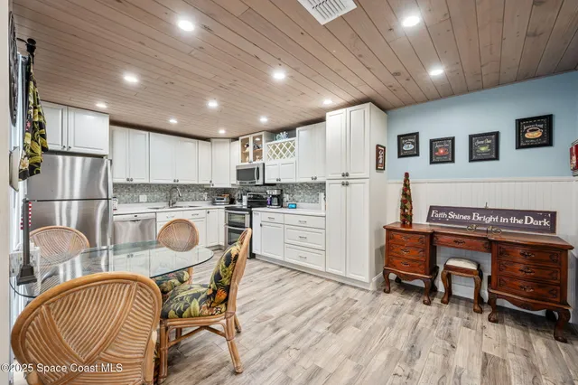 a dining room with furniture and a rug