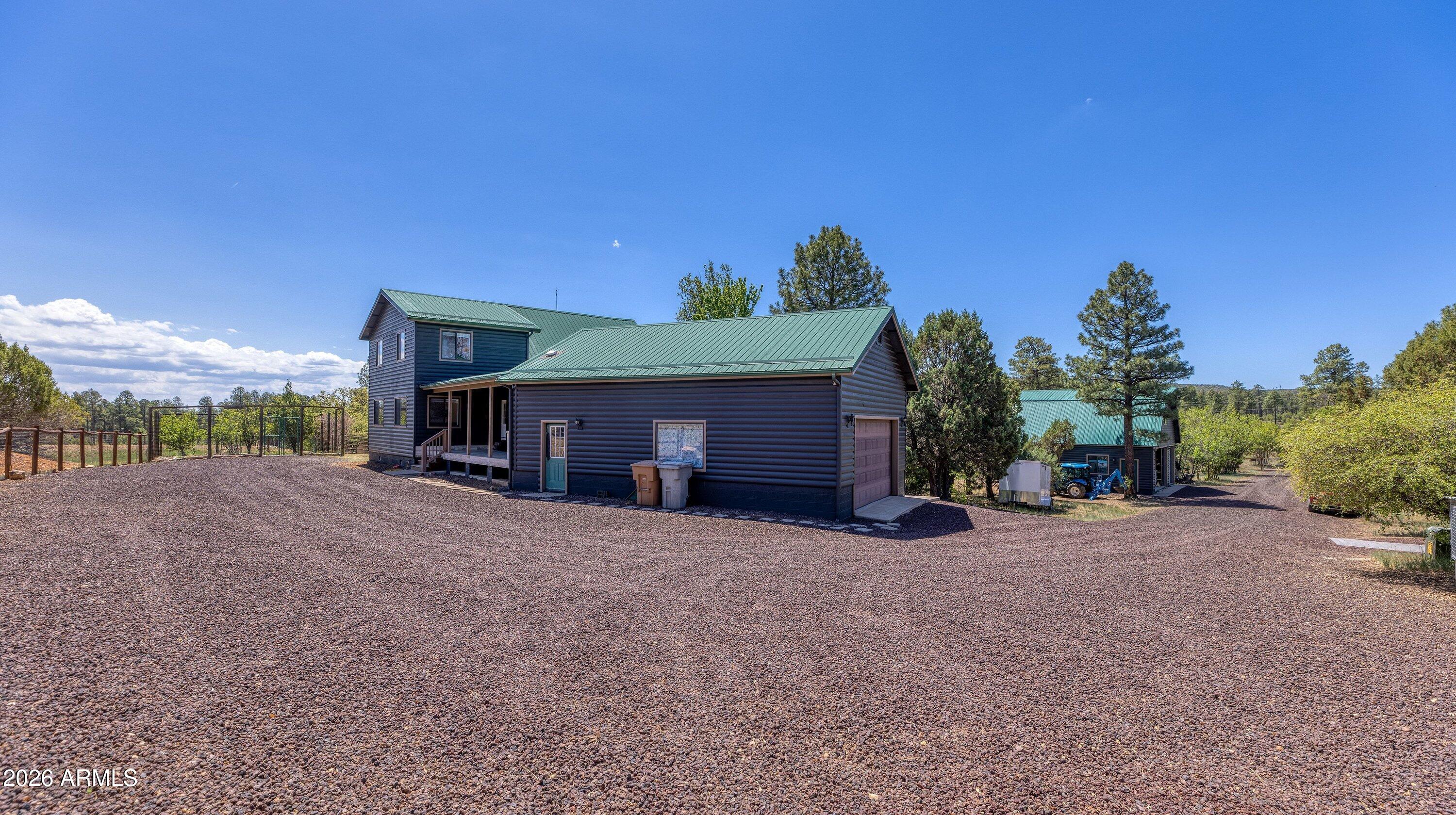 5182 Pinedale Wash Road Pinedale, AZ 85934 - Photo 38 of 54 a view of a house with a yard and garage