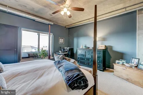 a bed room with a bed and a chandelier