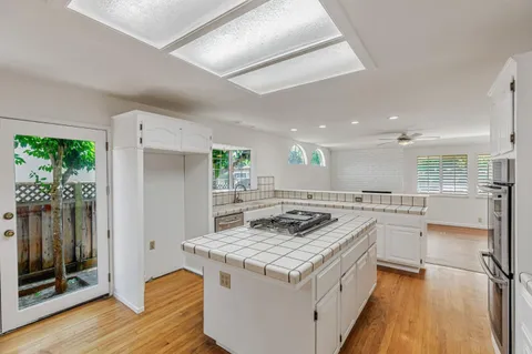a kitchen with stainless steel appliances granite countertop a sink and a refrigerator