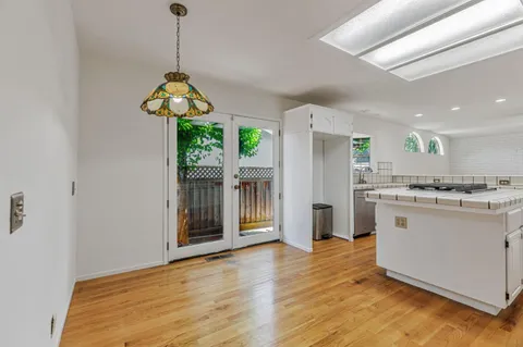 an empty room with windows and a fireplace