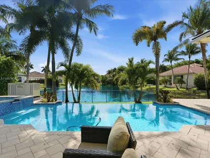 an aerial view of a house with swimming pool and outdoor space