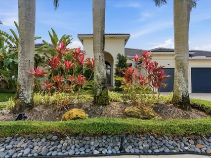 a front view of a house with a garden