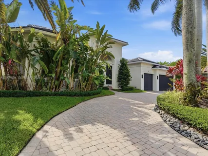 a view of a house with a yard and plants