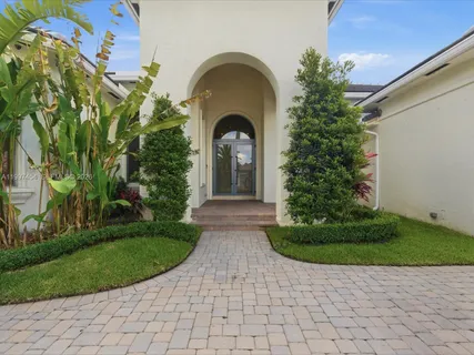 a view of a house with swimming pool and sitting area
