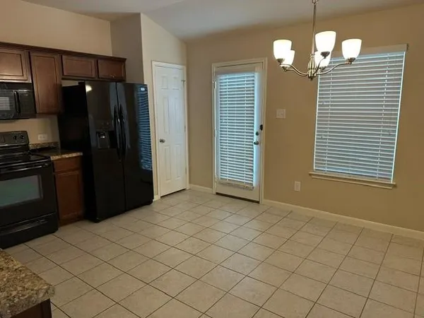 a view of a kitchen with a dishwasher cabinets and a window