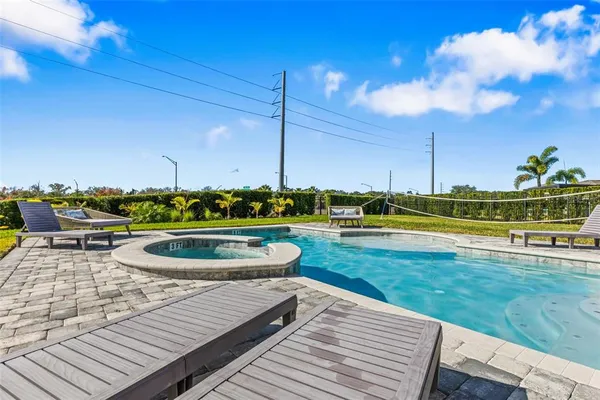a view of a house with swimming pool and a yard