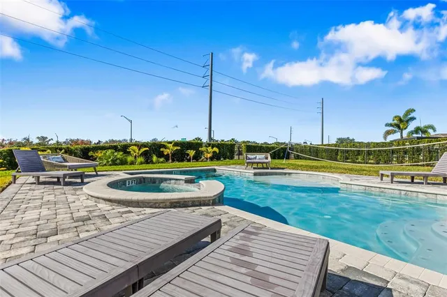 a view of a house with swimming pool and a yard