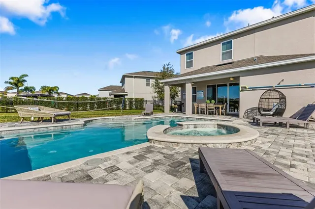 a view of swimming pool with outdoor seating and city view