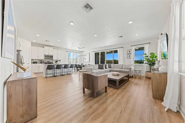 a living room with furniture and a wooden floor