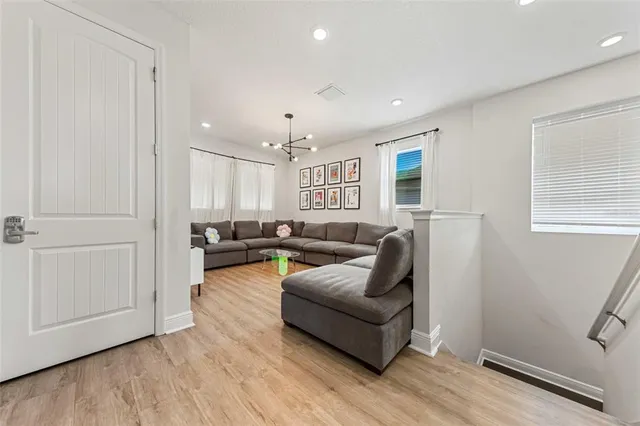 a spacious bedroom with a bed and a chandelier