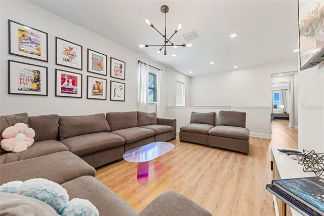 a bathroom with a double vanity sink a toilet and a large mirror