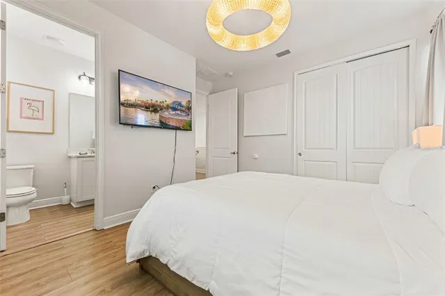 a bedroom with two beds and a chandelier