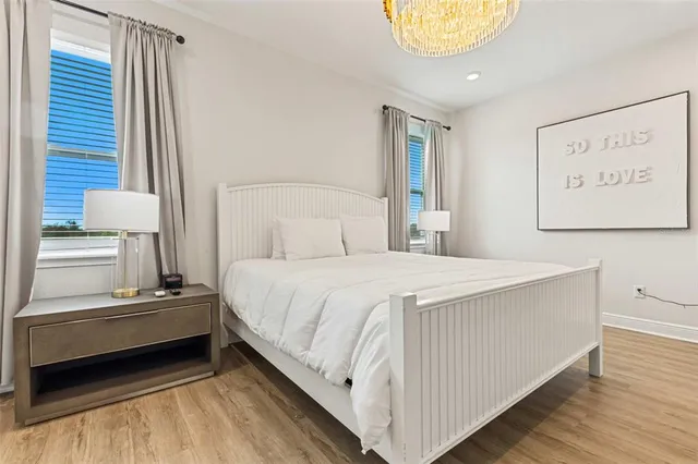 a bedroom with a bed and a painting on the wall