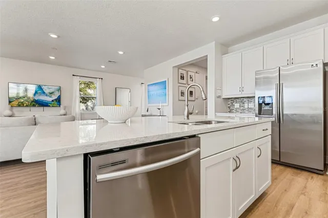 a kitchen with stainless steel appliances granite countertop a stove and a microwave