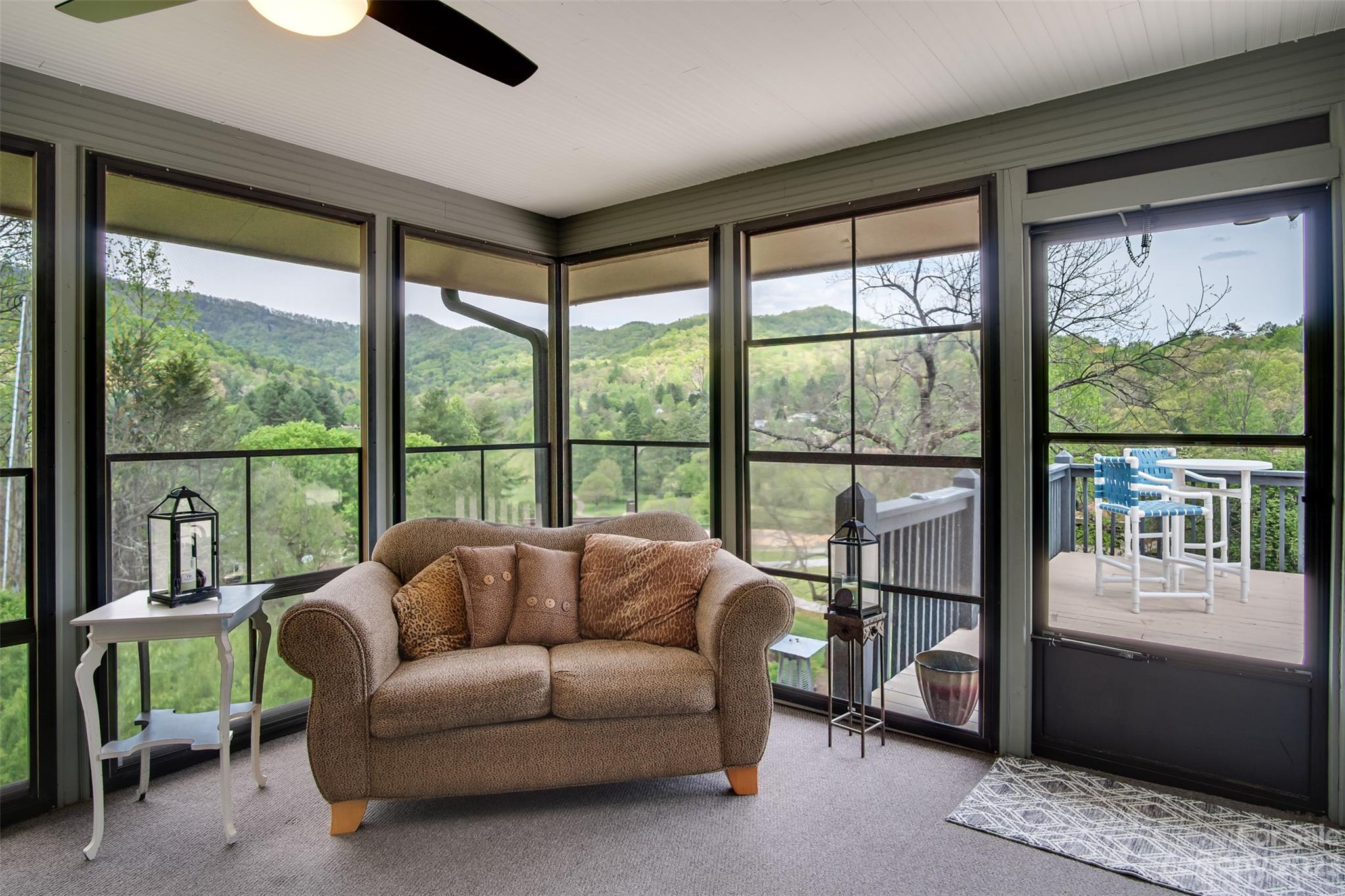209 Emerald Hill Road Franklin, NC 28734 - Photo 13 of 33 a living room with furniture and a floor to ceiling window