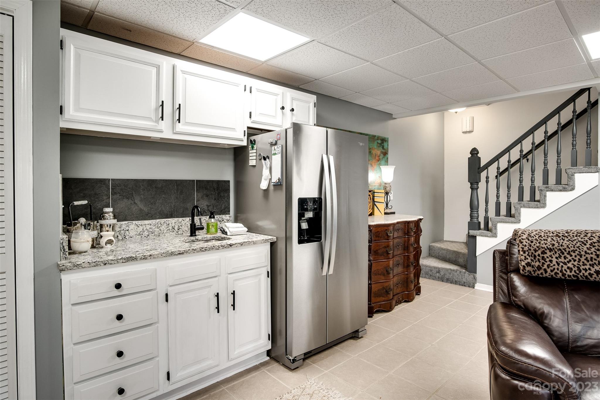 209 Emerald Hill Road Franklin, NC 28734 - Photo 18 of 33 a kitchen with a refrigerator and cabinets