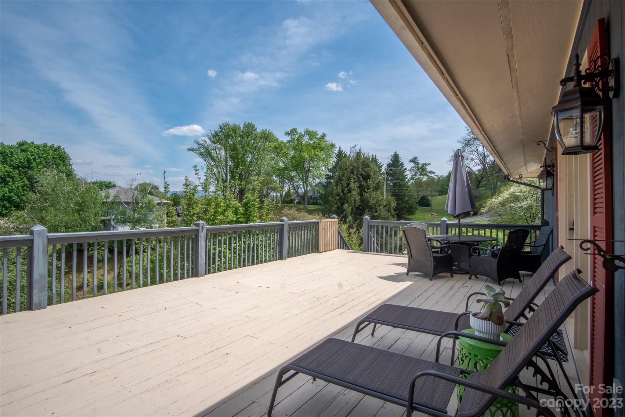 209 Emerald Hill Road Franklin, NC 28734 - Photo 22 of 33 a view of a patio with couches chairs with wooden floor
