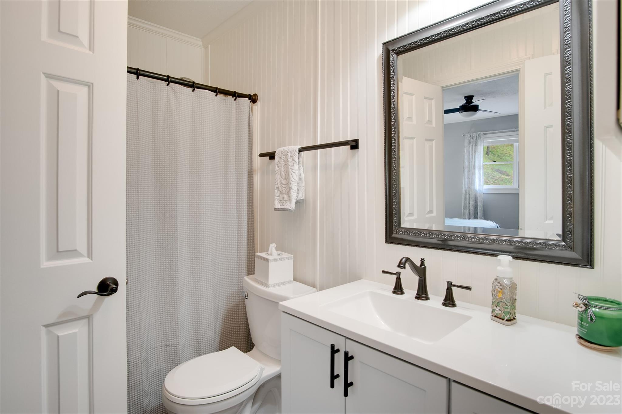 209 Emerald Hill Road Franklin, NC 28734 - Photo 9 of 33 a bathroom with a sink vanity mirror and toilet
