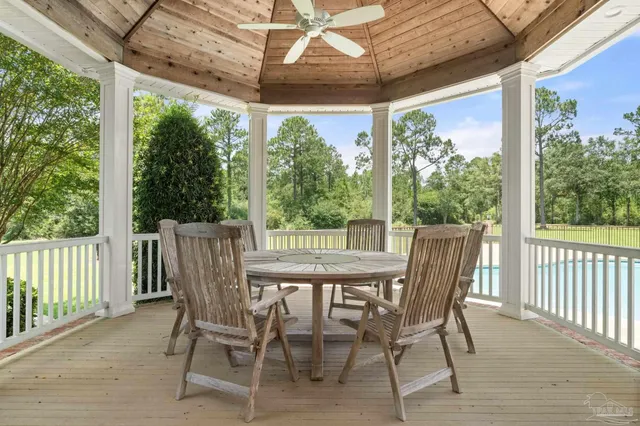 a view of a patio with a table chairs and wooden floor