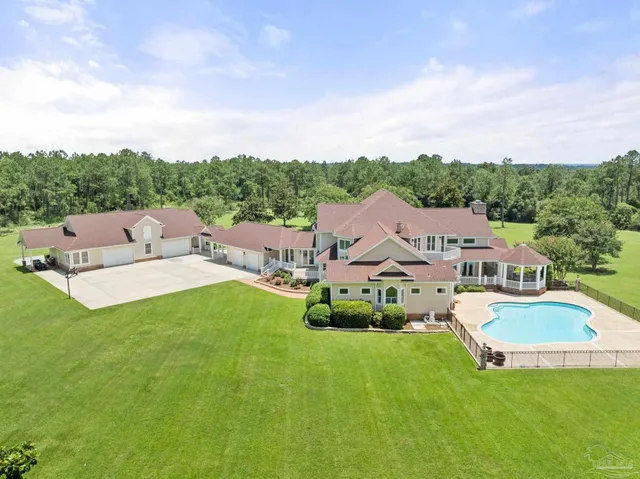 a view of yard with swimming pool and green space