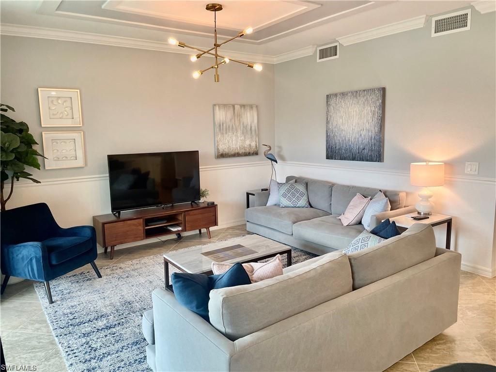 9590 Trevi Court, Unit 5337 Naples, FL 34113 - Photo 15 of 35 a living room with furniture and a flat screen tv