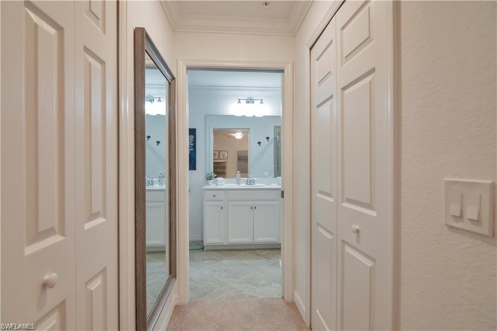9590 Trevi Court, Unit 5337 Naples, FL 34113 - Photo 19 of 35 a bathroom with a granite countertop sink and a mirror