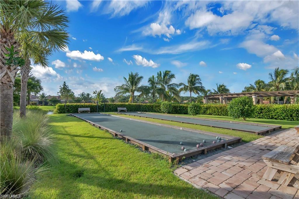 9590 Trevi Court, Unit 5337 Naples, FL 34113 - Photo 34 of 35 a view of a playground with basketball court