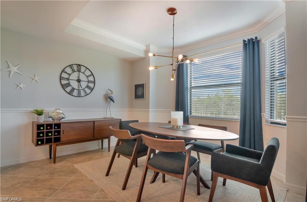 9590 Trevi Court, Unit 5337 Naples, FL 34113 - Photo 7 of 35 a view of a dining room with furniture window and wooden floor