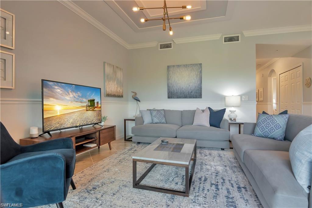 9590 Trevi Court, Unit 5337 Naples, FL 34113 - Photo 8 of 35 a living room with furniture and a flat screen tv