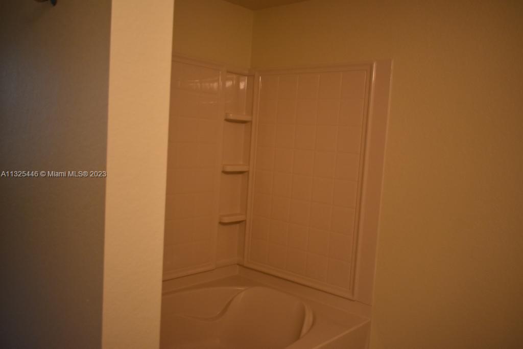 6520 West Sample Road, Unit 6520 Coral Springs, FL 33067 - Photo 25 of 33 a bathroom with a shower